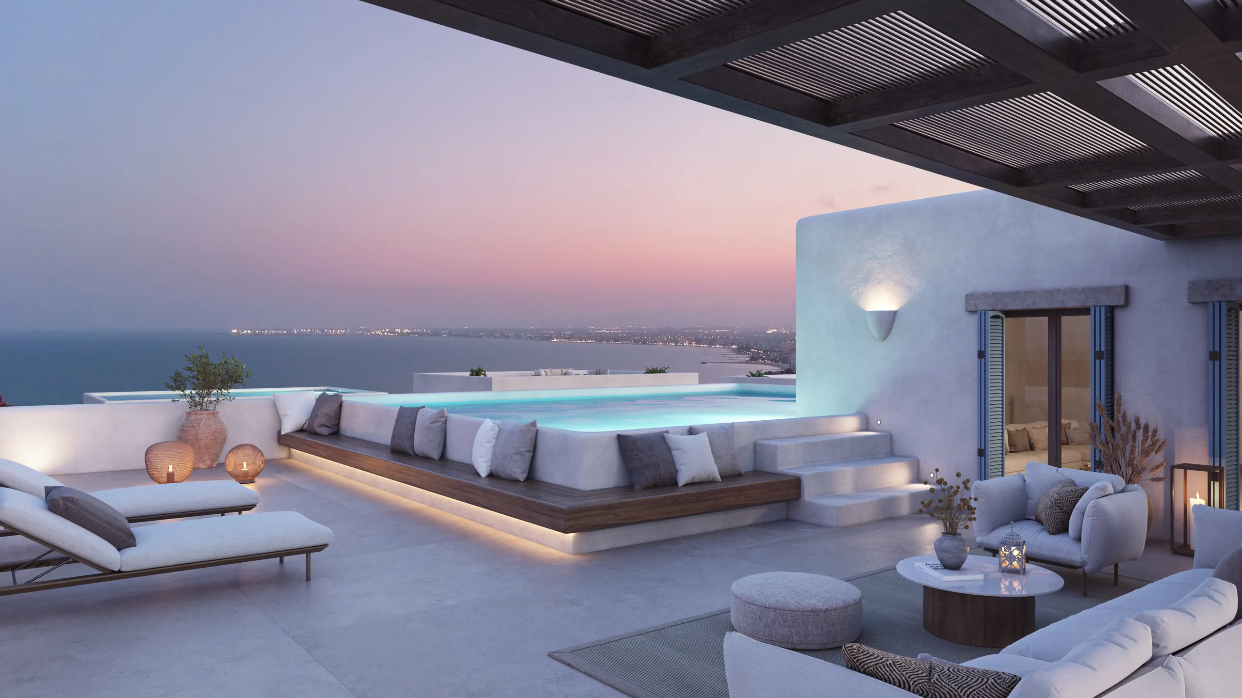 Terraza de un ático del poblado al atardecer, con la piscina y el mar al fondo
